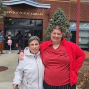 two women standing out the Warwick Public Library